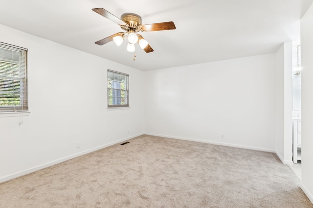 unfurnished room featuring light carpet and ceiling fan