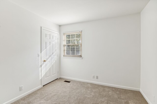 empty room with light colored carpet