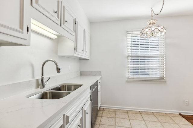 kitchen featuring white cabinetry, light stone countertops, hanging light fixtures, sink, and stainless steel dishwasher