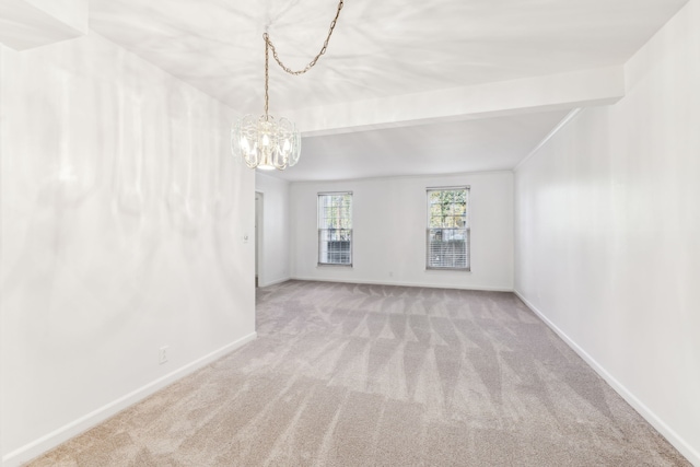 carpeted spare room featuring a notable chandelier and beam ceiling