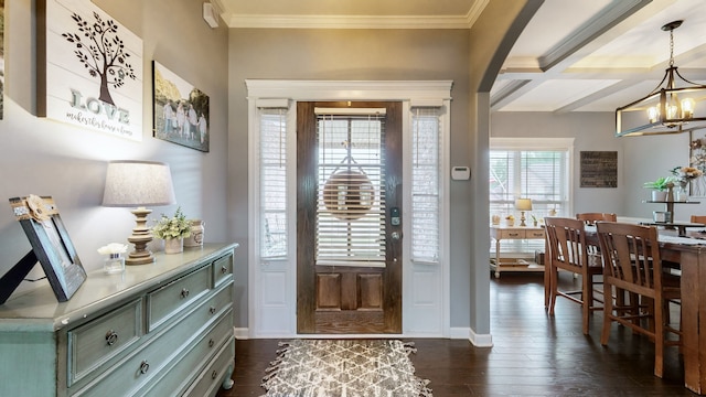 foyer featuring beamed ceiling, ornamental molding, dark hardwood / wood-style floors, and a chandelier