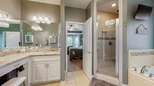 bathroom featuring vanity, tile patterned floors, ceiling fan, and plus walk in shower