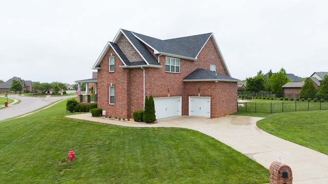 view of side of property featuring a garage and a lawn