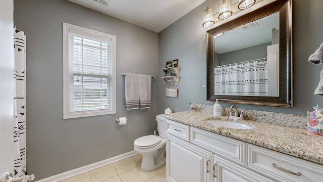 bathroom featuring vanity, tile patterned floors, and toilet