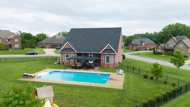 view of pool with a lawn, pool water feature, and a patio area