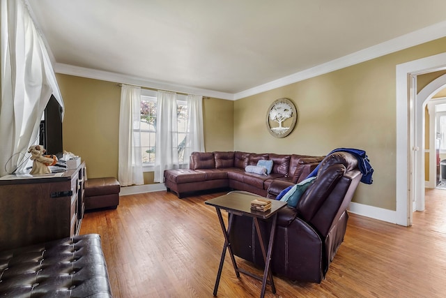 living room featuring hardwood / wood-style floors and crown molding