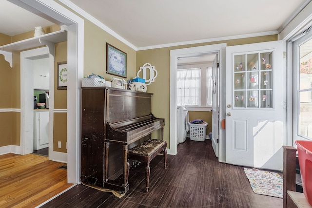 misc room featuring hardwood / wood-style floors, washer and clothes dryer, and ornamental molding