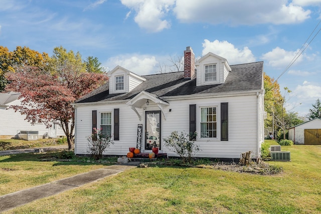 cape cod-style house featuring central AC and a front lawn