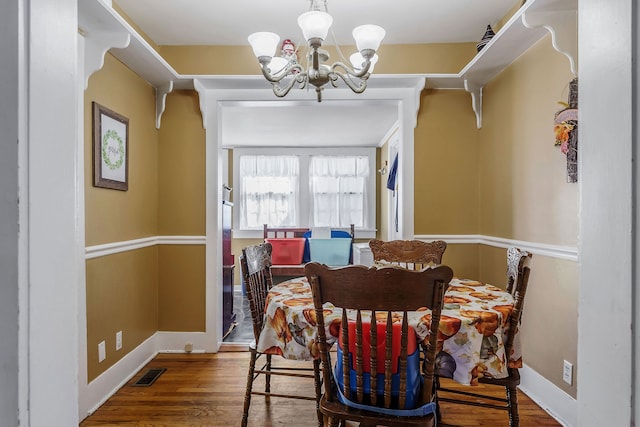 dining space featuring a chandelier and hardwood / wood-style floors