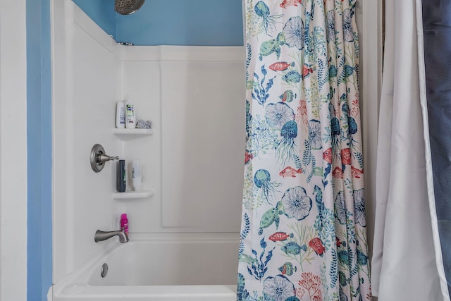 bathroom with shower / bath combo with shower curtain