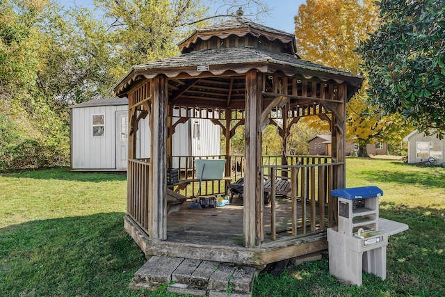 exterior space featuring a shed, a lawn, a deck, and a gazebo