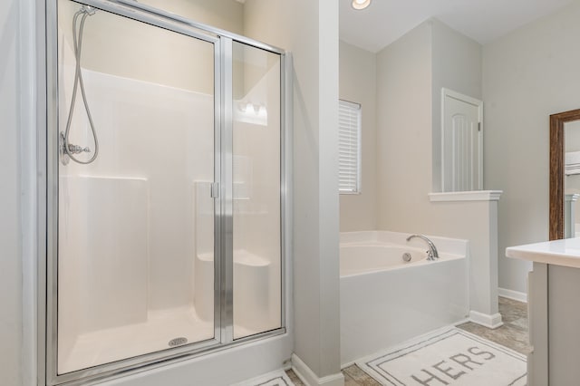 bathroom with tile patterned flooring, shower with separate bathtub, and vanity