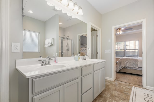 bathroom featuring ceiling fan, a shower with shower door, and vanity