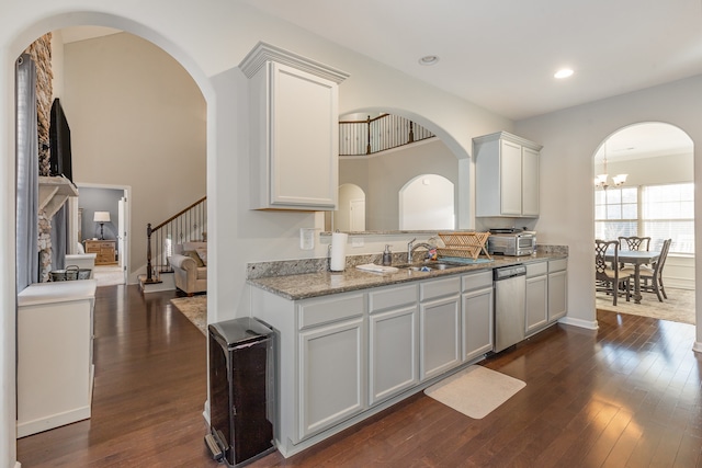 kitchen with dark hardwood / wood-style flooring, sink, dishwasher, a chandelier, and white cabinetry