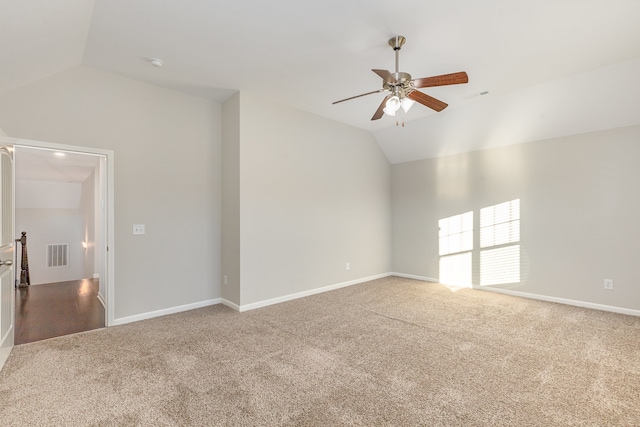 carpeted spare room with ceiling fan and lofted ceiling