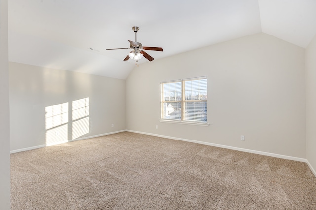 empty room featuring carpet flooring, ceiling fan, and vaulted ceiling