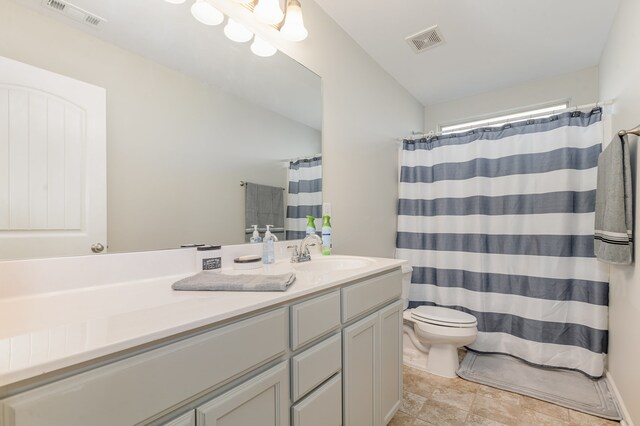 bathroom with vanity, a shower with shower curtain, and toilet