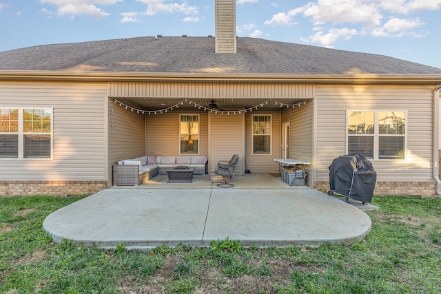 back of house with an outdoor living space and a patio area