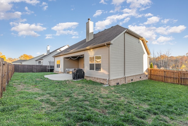 rear view of property with a patio area and a yard