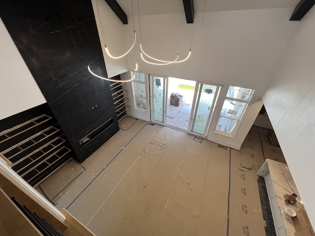 entrance foyer featuring beamed ceiling and a towering ceiling