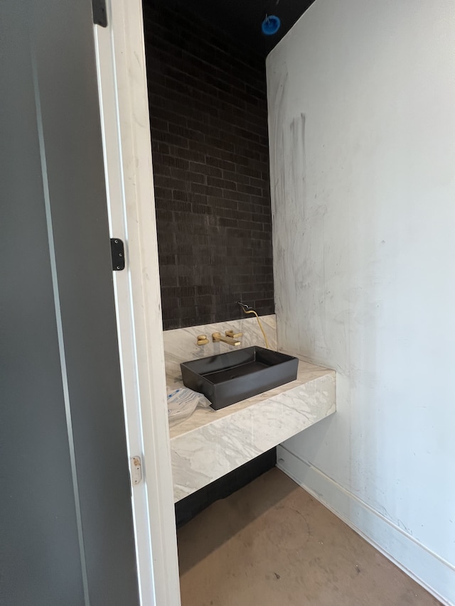 bathroom featuring concrete floors