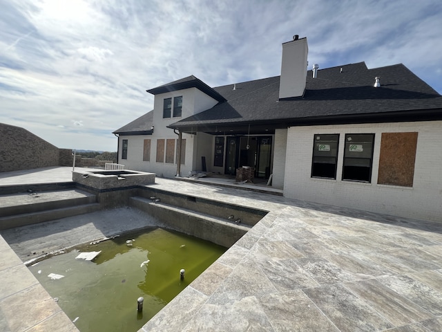 view of swimming pool featuring an in ground hot tub and a patio area