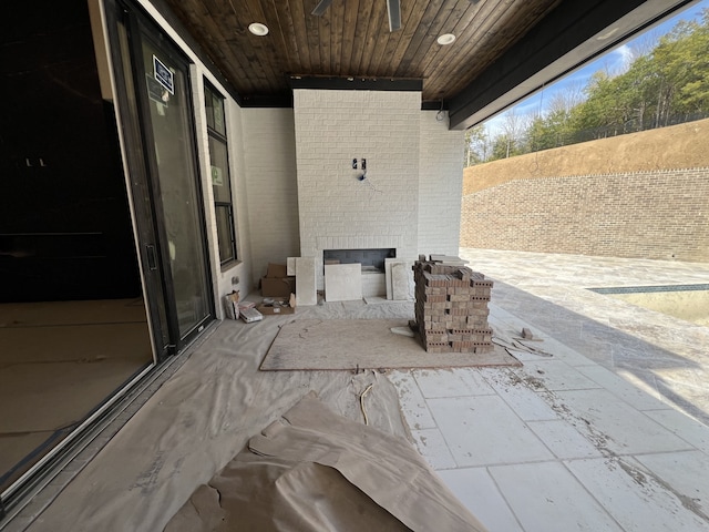 view of patio / terrace featuring an outdoor brick fireplace and ceiling fan