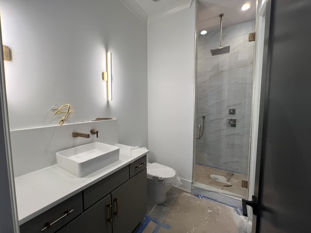 bathroom with a shower with door, vanity, concrete floors, and toilet