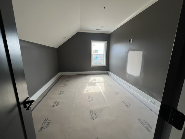 additional living space with vaulted ceiling