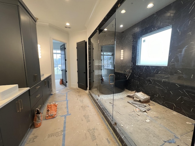 bathroom featuring ornamental molding, vanity, and walk in shower