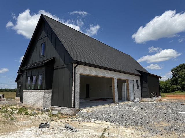17 Solitude Way, Clarksville, TN 37043 - view of side of home featuring brick siding, a garage, board and batten siding, and a shingled roof