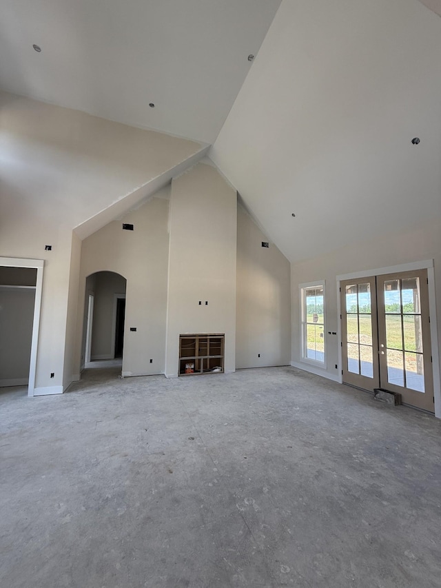 17 Solitude Way, Clarksville, TN 37043 - unfurnished living room featuring high vaulted ceiling, french doors, arched walkways, and baseboards