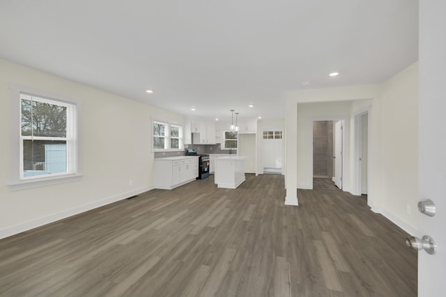 unfurnished living room with dark hardwood / wood-style flooring