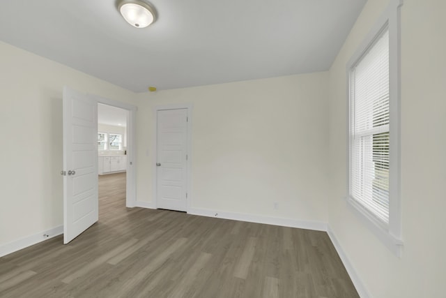 unfurnished room featuring hardwood / wood-style floors