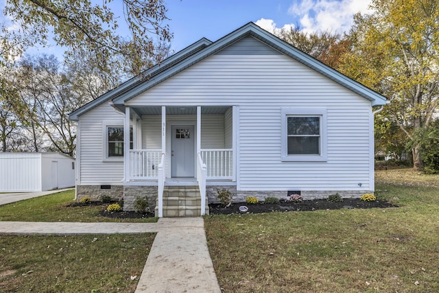 bungalow with a front lawn and a porch