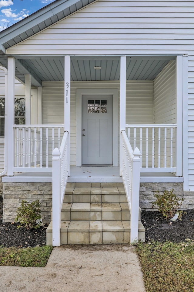 entrance to property featuring a porch