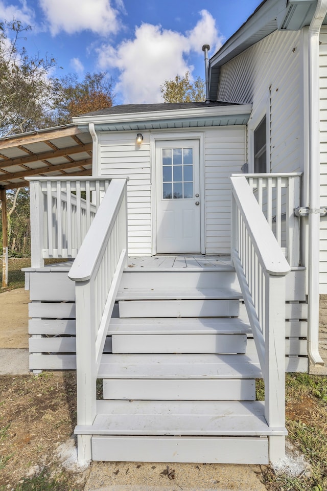 view of exterior entry featuring a deck