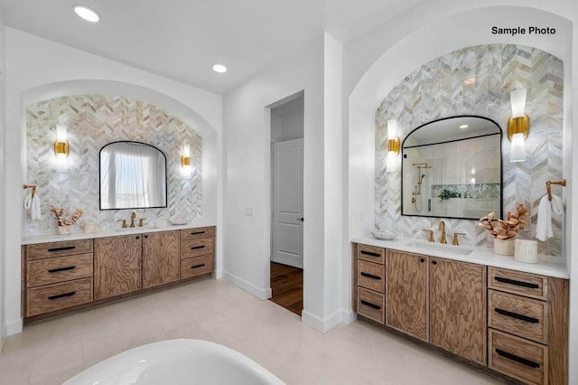 18 Solitude Way, Clarksville, TN 37043 - bathroom with two vanities, a freestanding tub, tiled shower, and recessed lighting