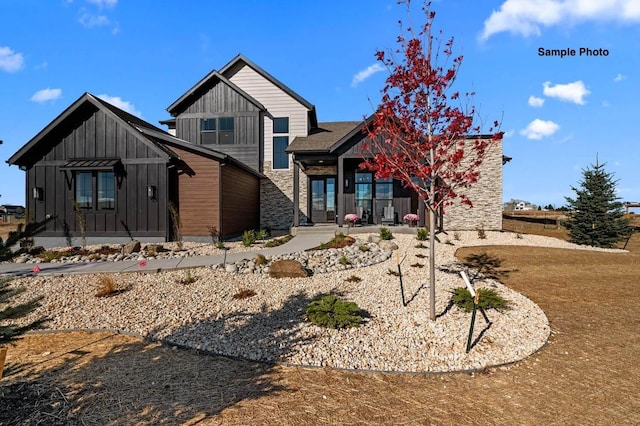 18 Solitude Way, Clarksville, TN 37043 - view of front facade with board and batten siding, stone siding, covered porch, and an attached garage