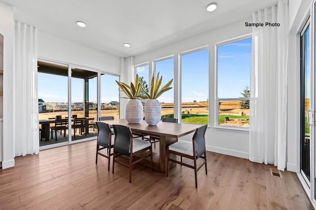 dining area featuring light wood-type flooring