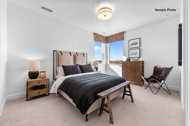 bedroom with light colored carpet