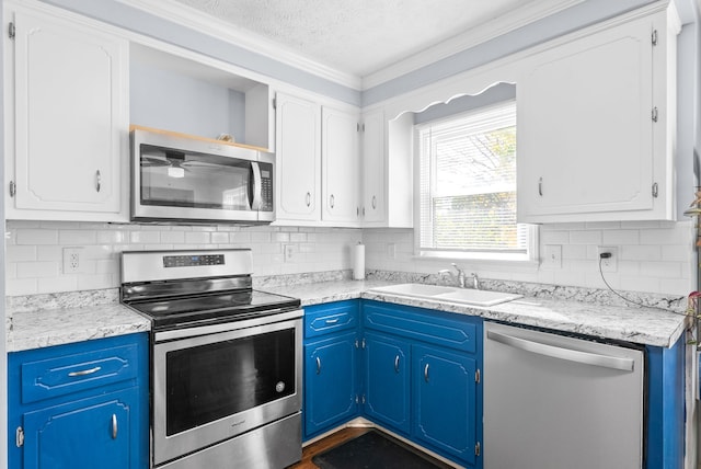 kitchen with sink, appliances with stainless steel finishes, a textured ceiling, blue cabinets, and white cabinets