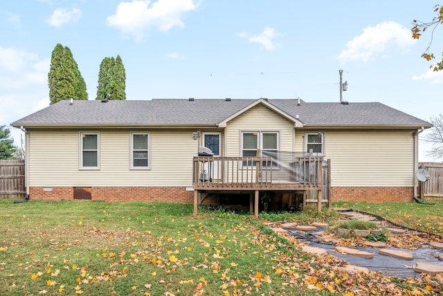 back of property with a lawn and a wooden deck