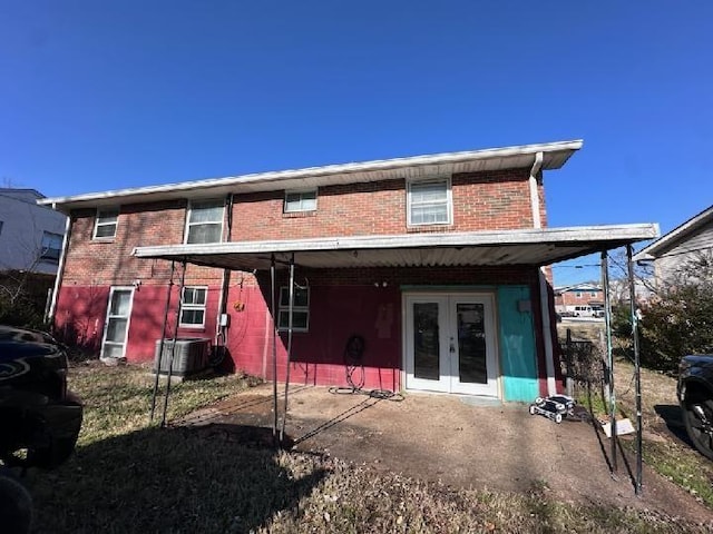 rear view of house with french doors and central AC unit