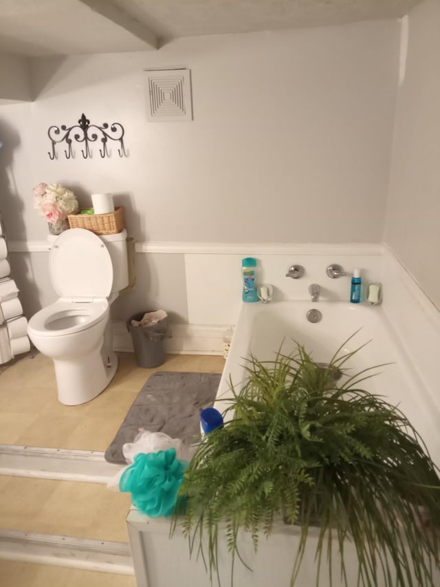 bathroom featuring tile patterned flooring and toilet