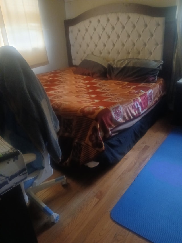 bedroom featuring wood-type flooring