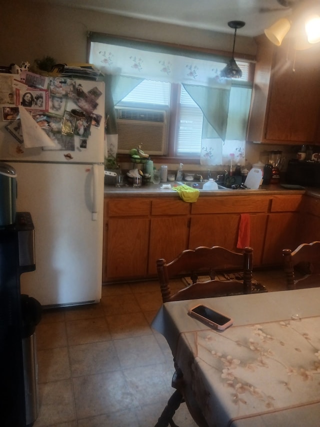 kitchen with pendant lighting, cooling unit, and white refrigerator