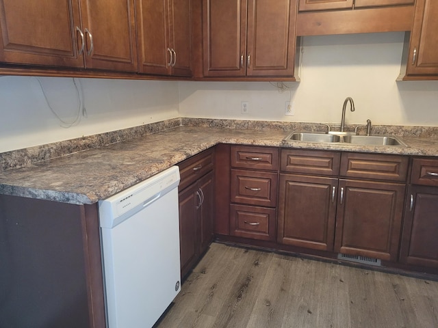 kitchen with dark hardwood / wood-style flooring, sink, dark brown cabinetry, and dishwasher