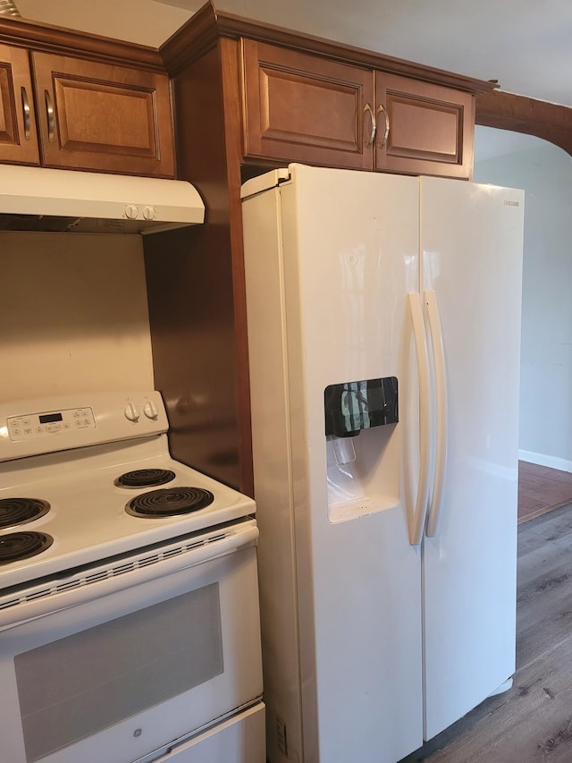 kitchen featuring hardwood / wood-style flooring and white appliances