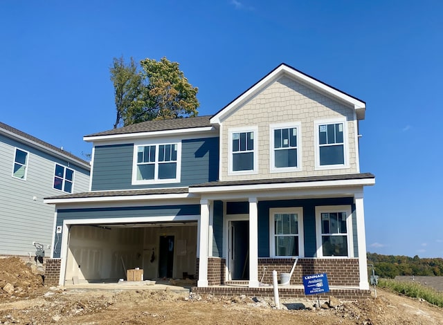 craftsman inspired home featuring a garage and covered porch